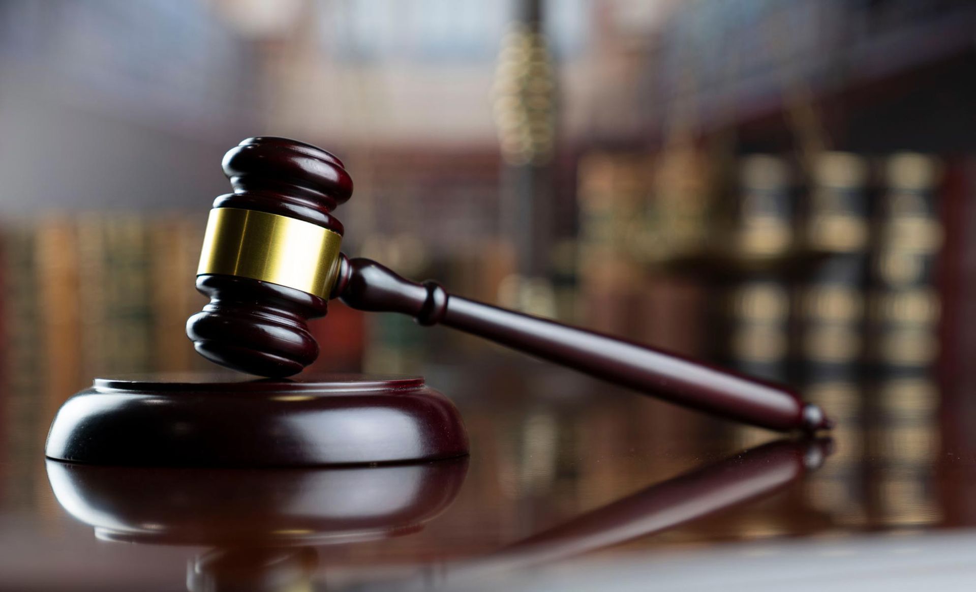 A wooden judge 's gavel is sitting on top of a wooden block.
