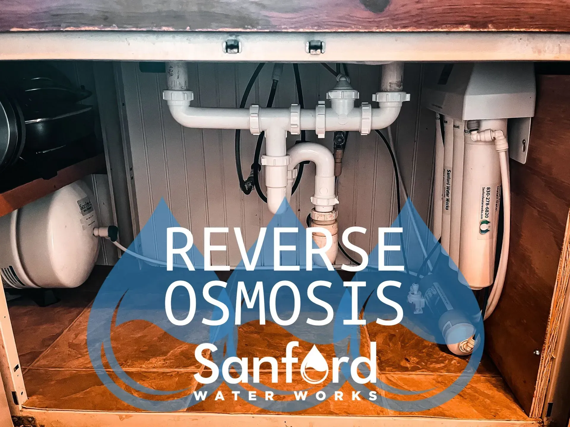 Reverse osmosis water filtration system installed under a kitchen sink.