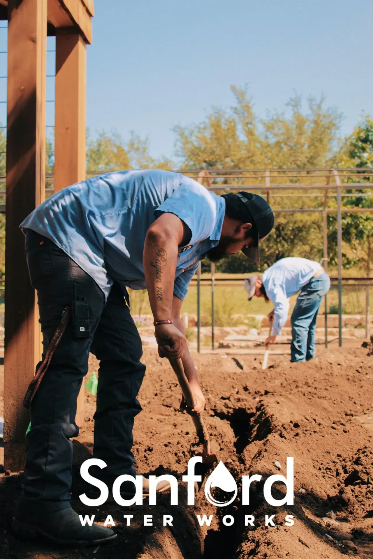 Two workers digging in dirt with shovels; “Sanford Water Works” logo.