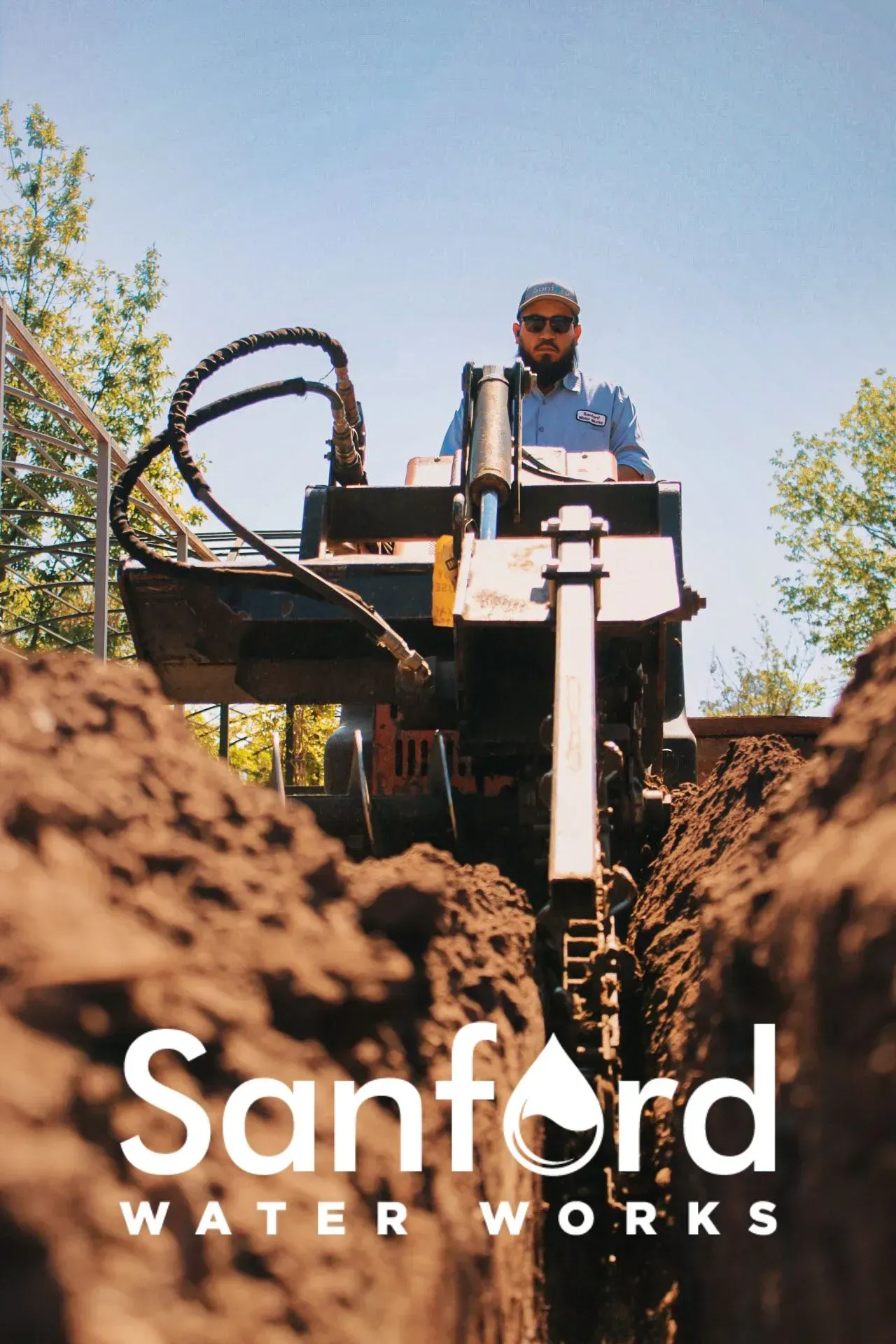 Man operating trenching machine for Sanford Water Works.
