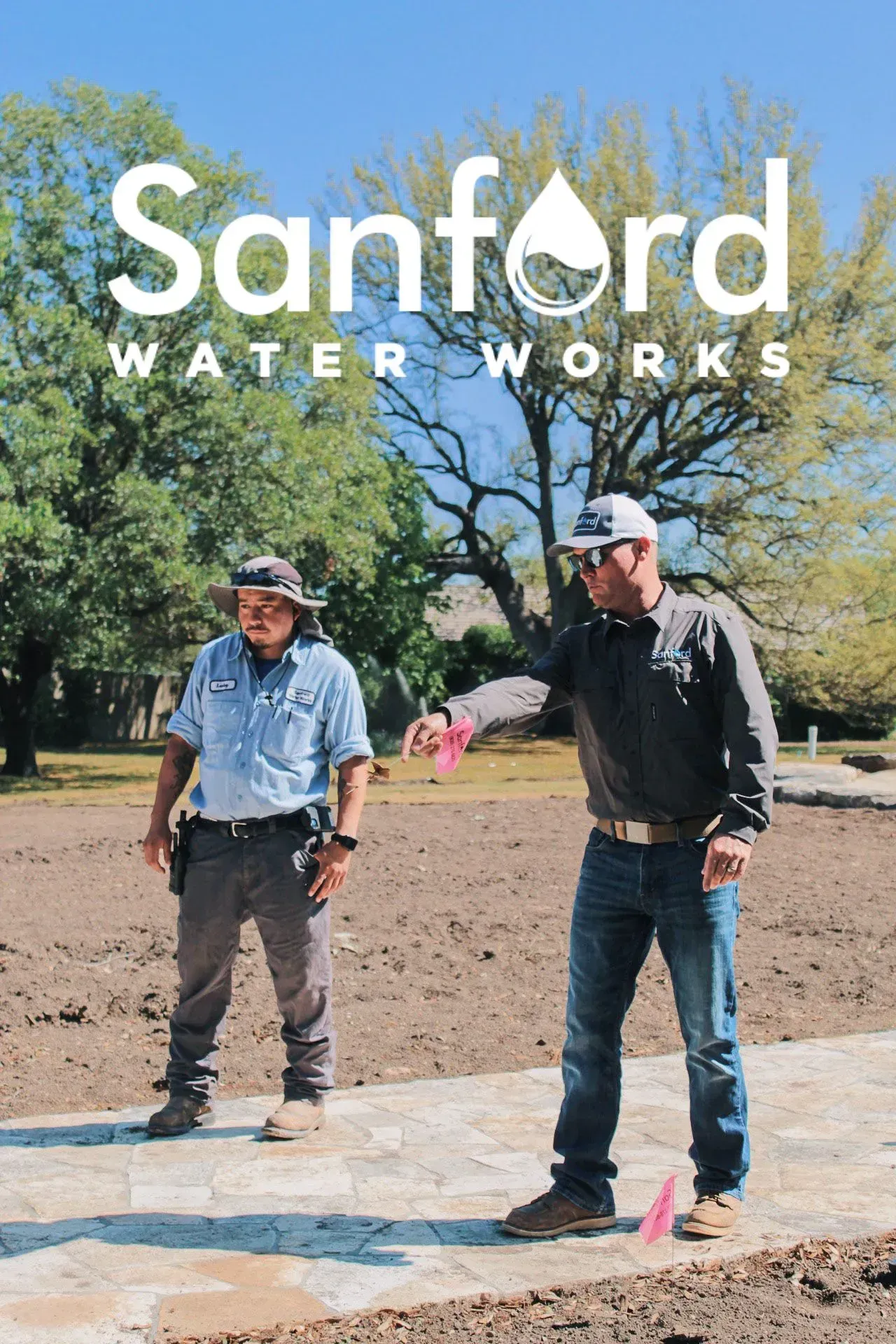 Two Sanford Water Works employees surveying a brown dirt area, one pointing, with logo above them.