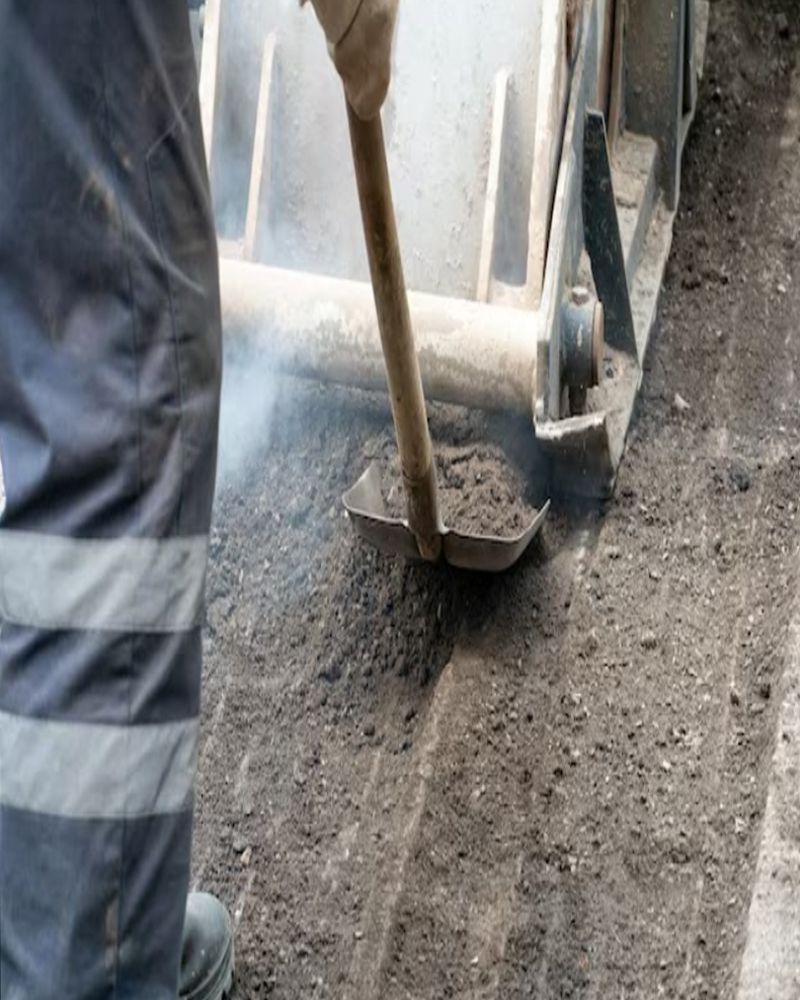 A person is using a shovel to dig a hole in the ground.