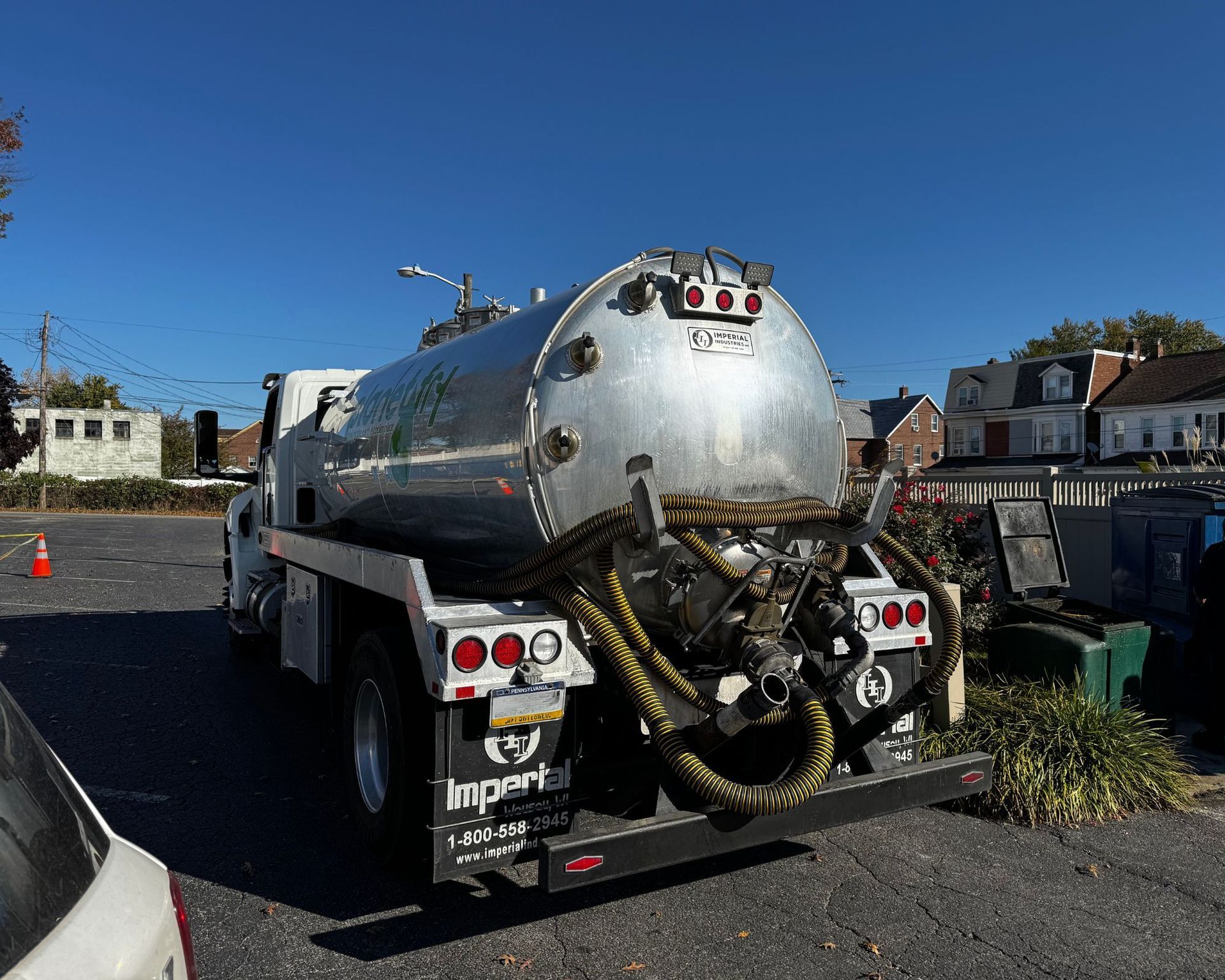 A large tanker truck is parked in a parking lot.