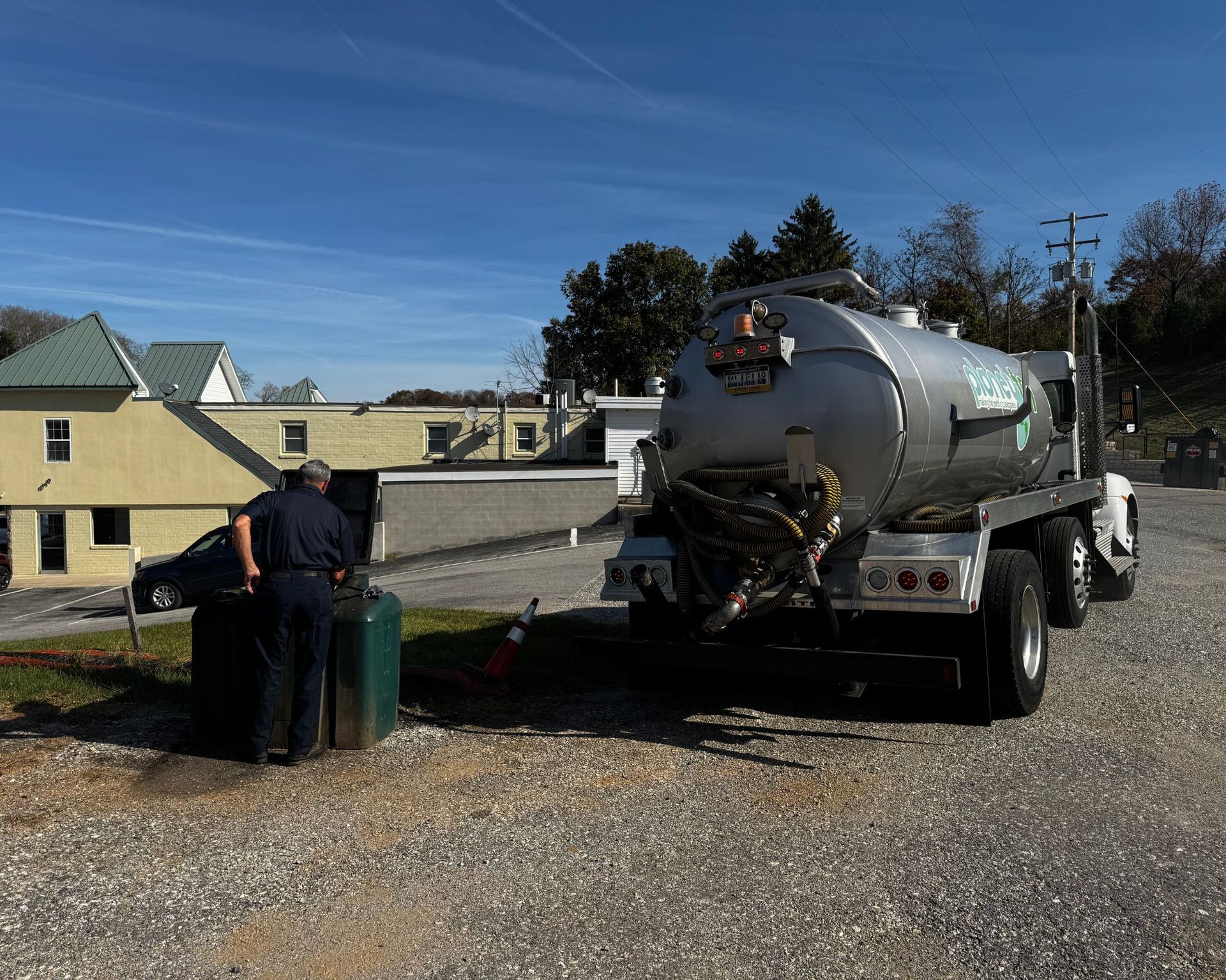 A man standing next to a tanker truck with the letters zd on the side