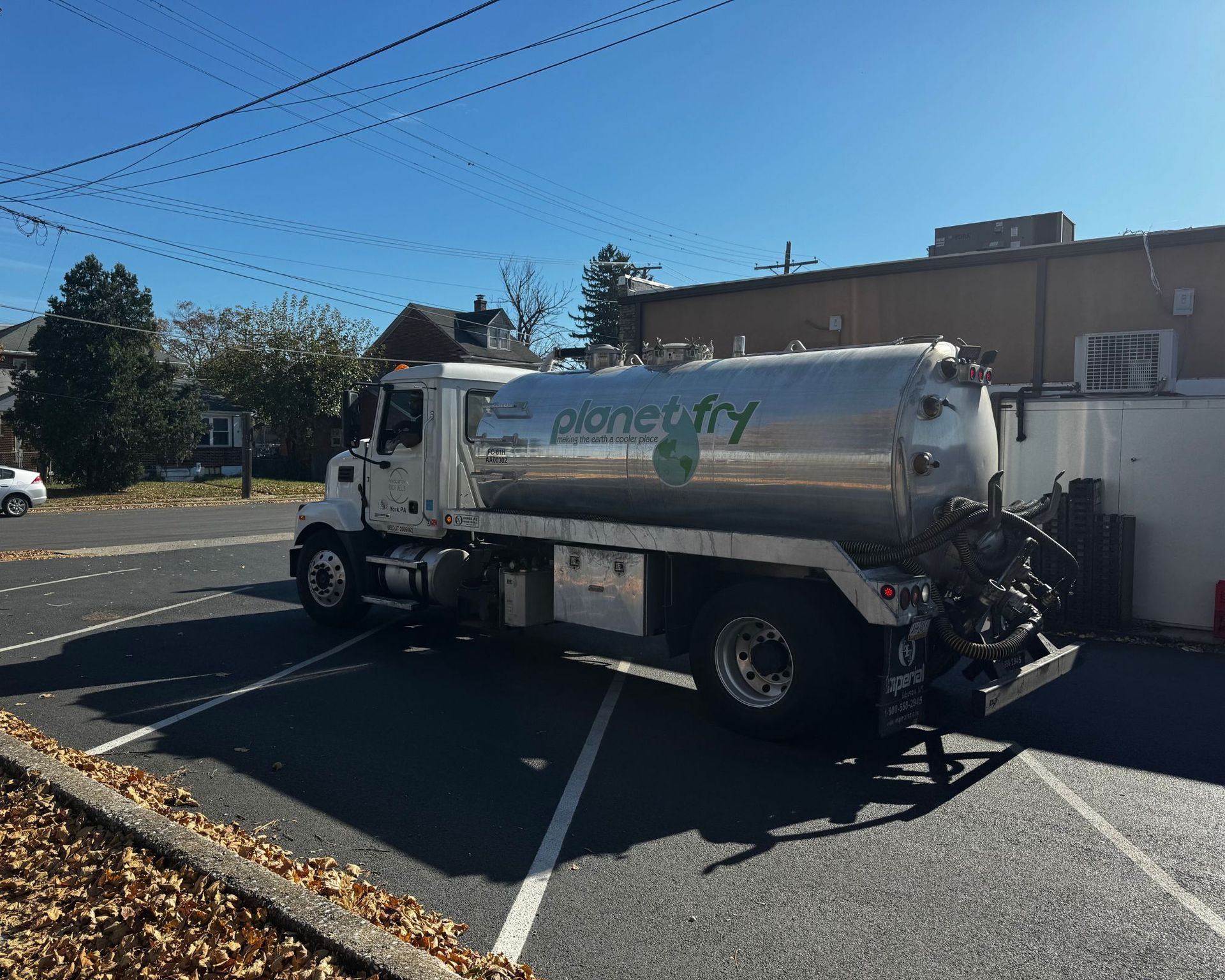 A planet city truck is parked in a parking lot