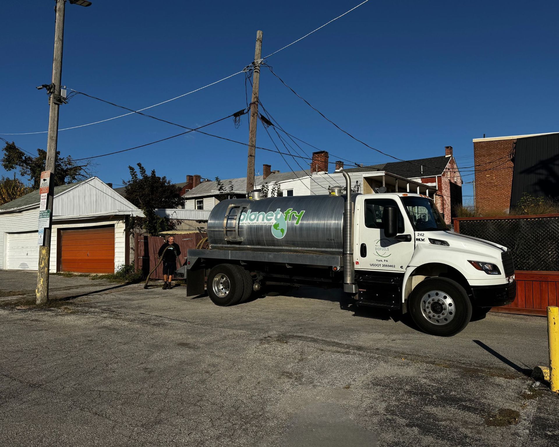 A water truck is parked on the side of the road