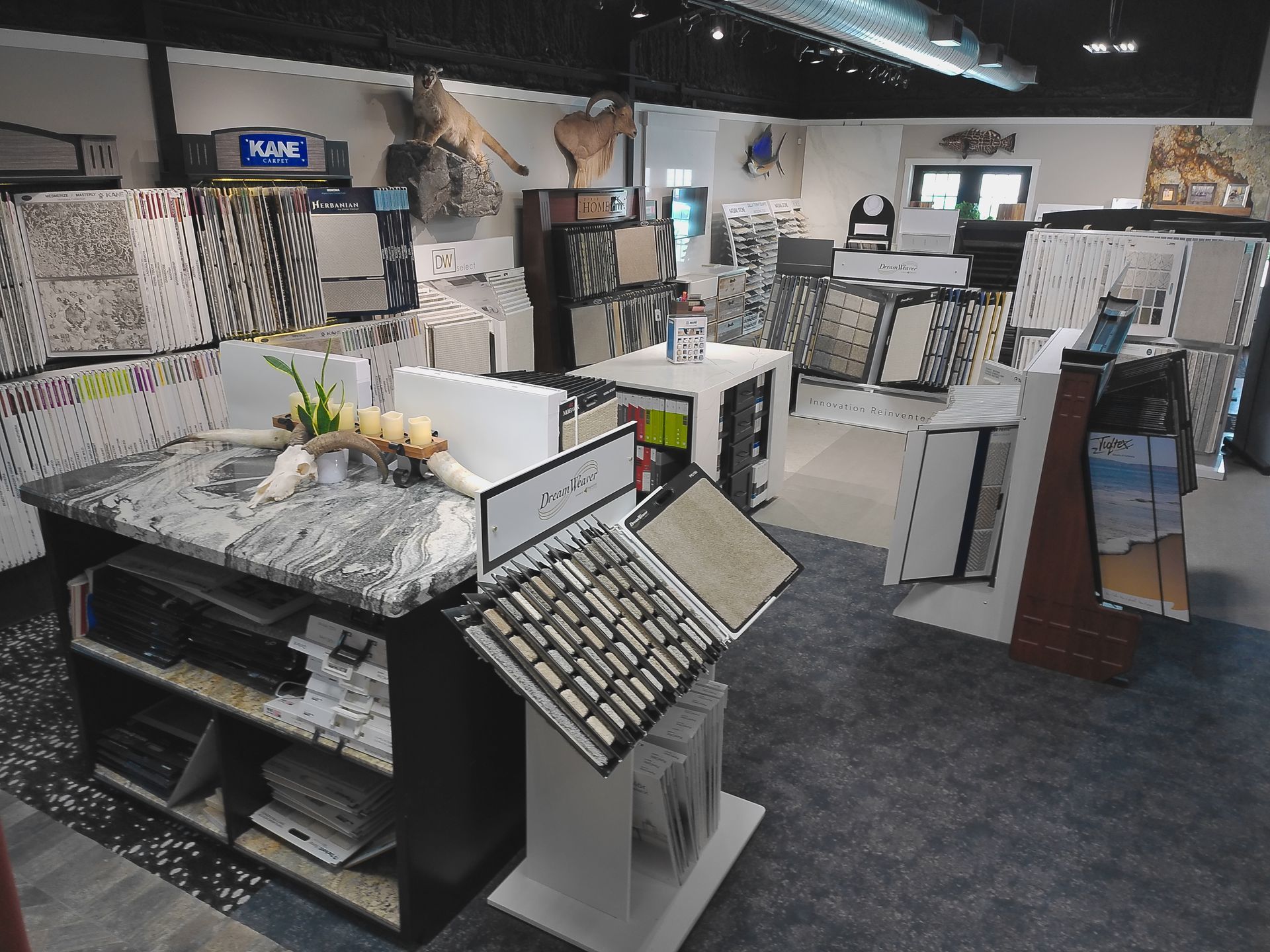 Interior of a tile and flooring showroom with display racks and sample boards