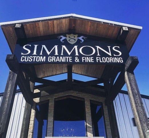Simmons Custom Granite & Fine Flooring sign above a building entrance
