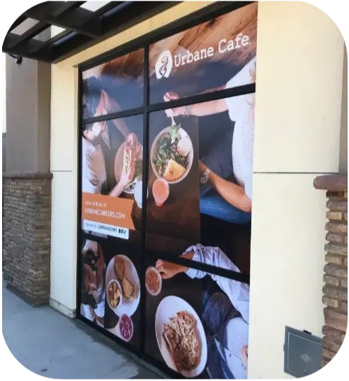 Urban Cafe storefront window wrap with food photos and logo on a beige building exterior