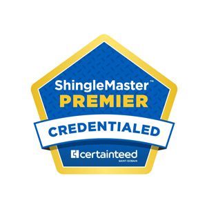 A blue and gold CertainTeed ShingleMaster Premier Credentialed badge in the shape of a pentagon.