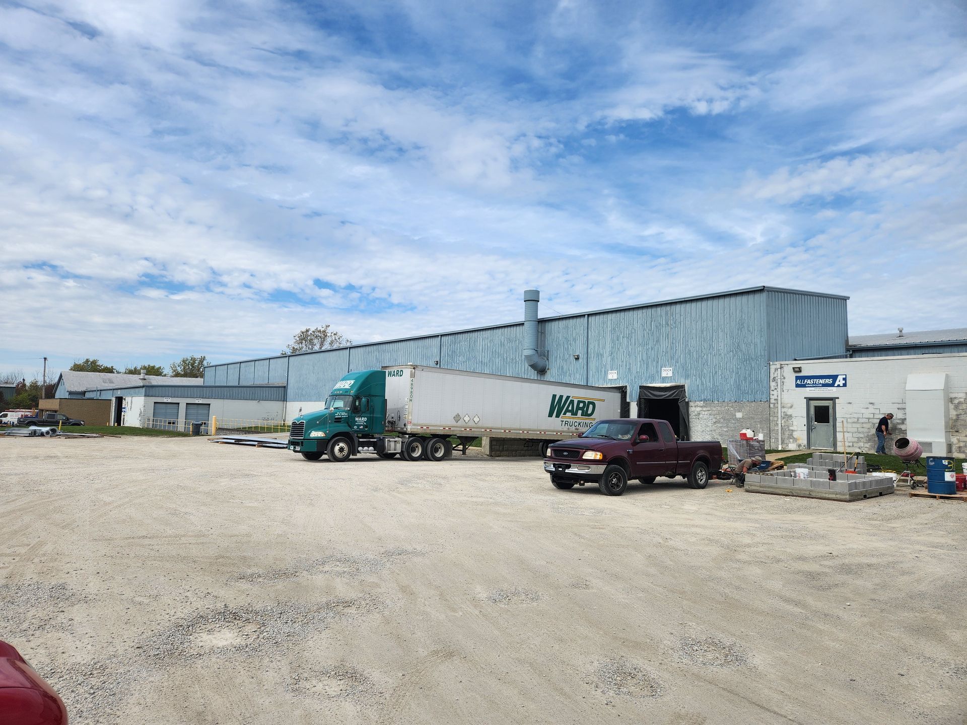 A truck is parked in front of a large building.