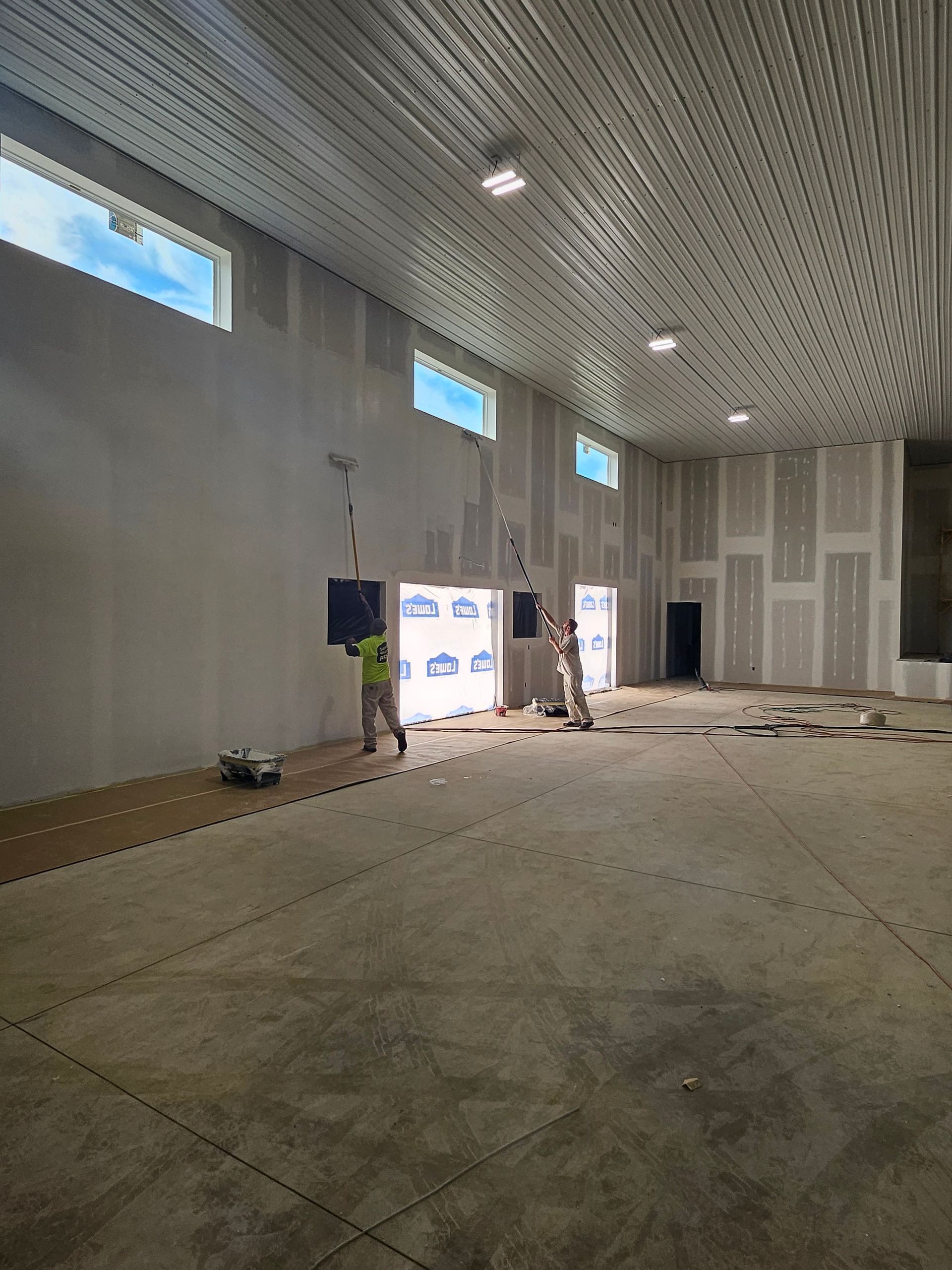 A large empty room with a ceiling that is being built.
