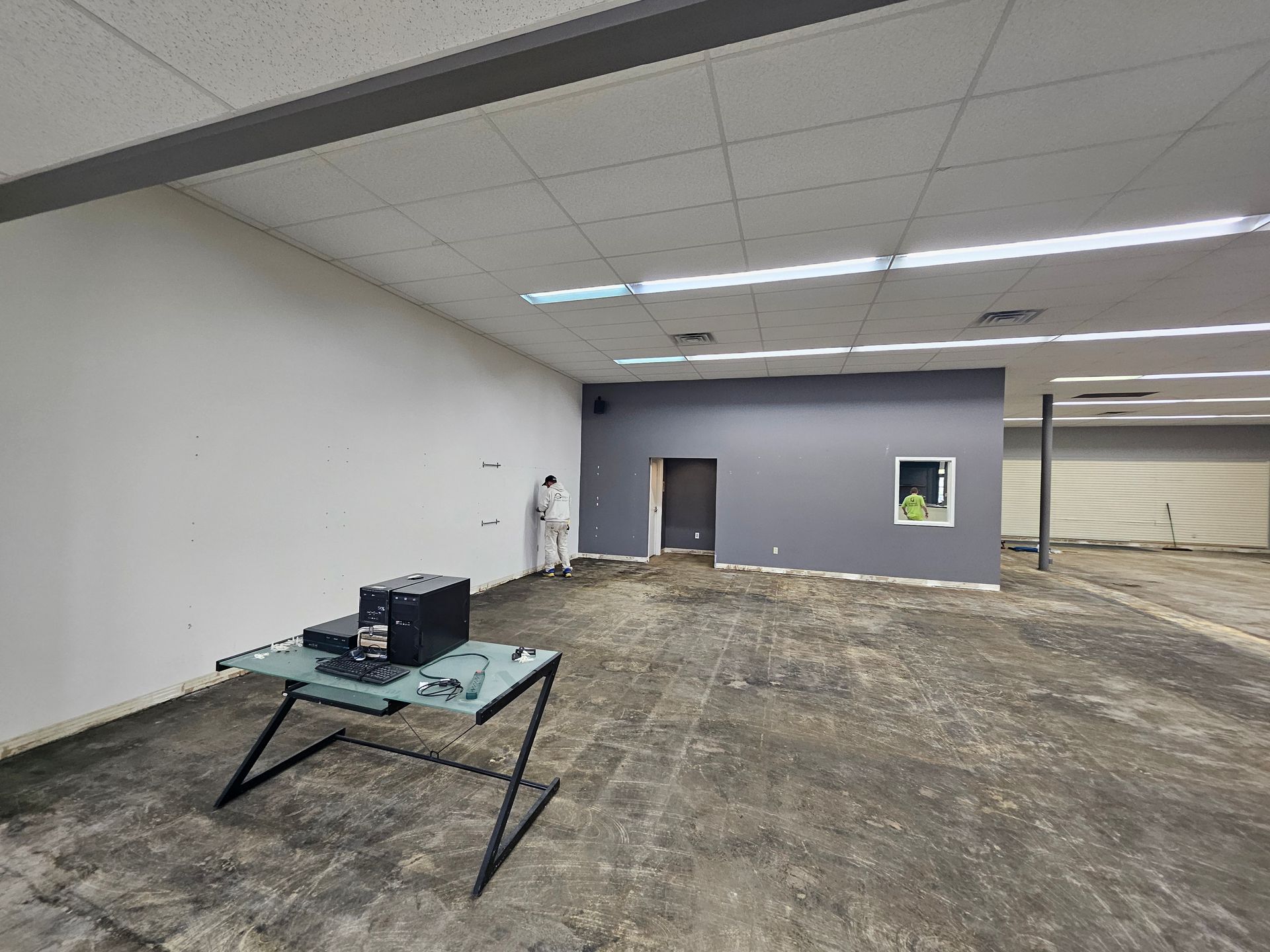 An empty room with a table and a computer on it.