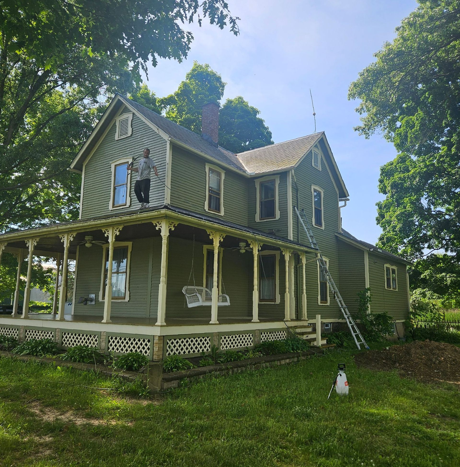 A man is standing on the porch of a house