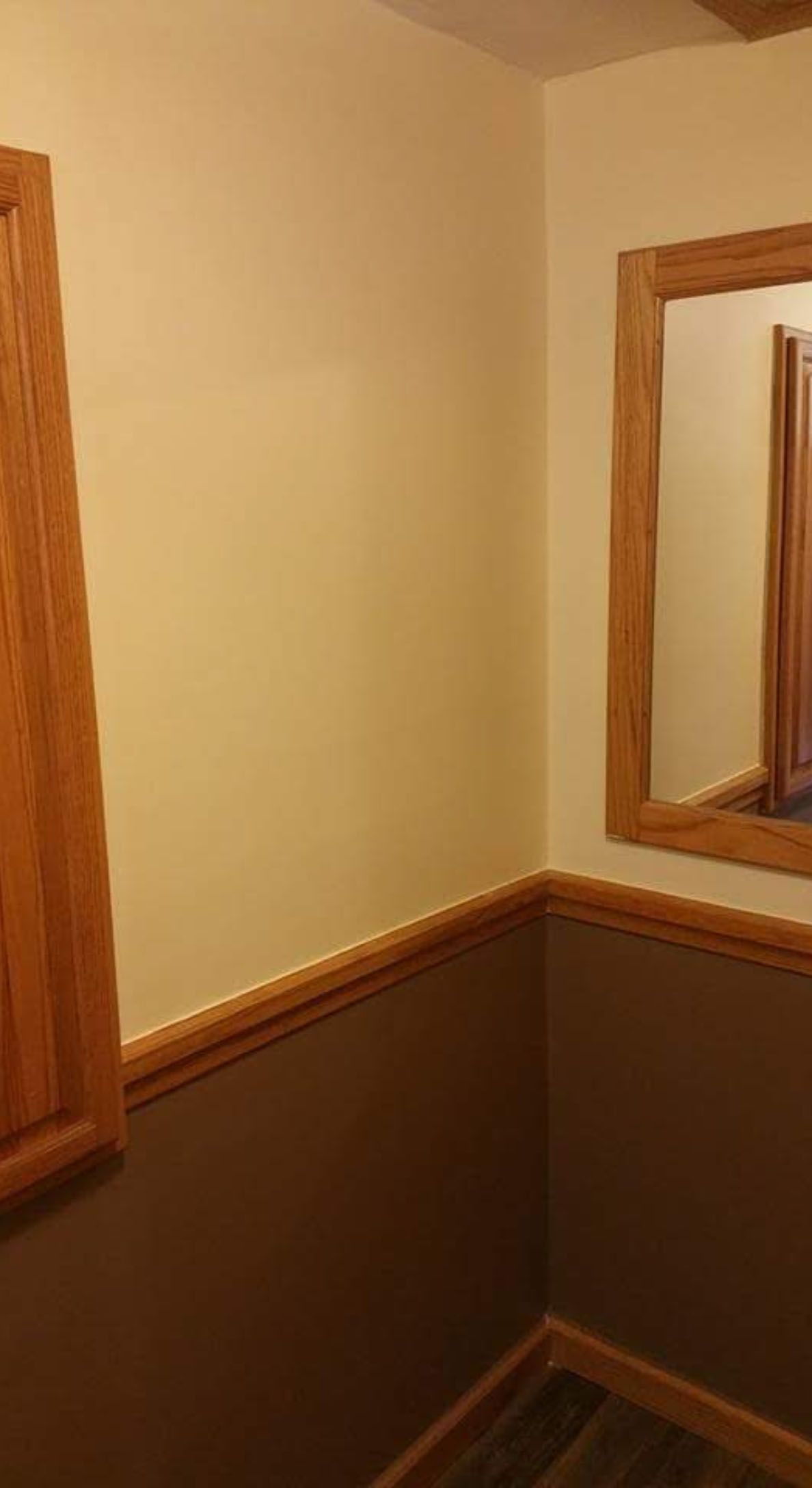 A room with a large mirror on the wall.