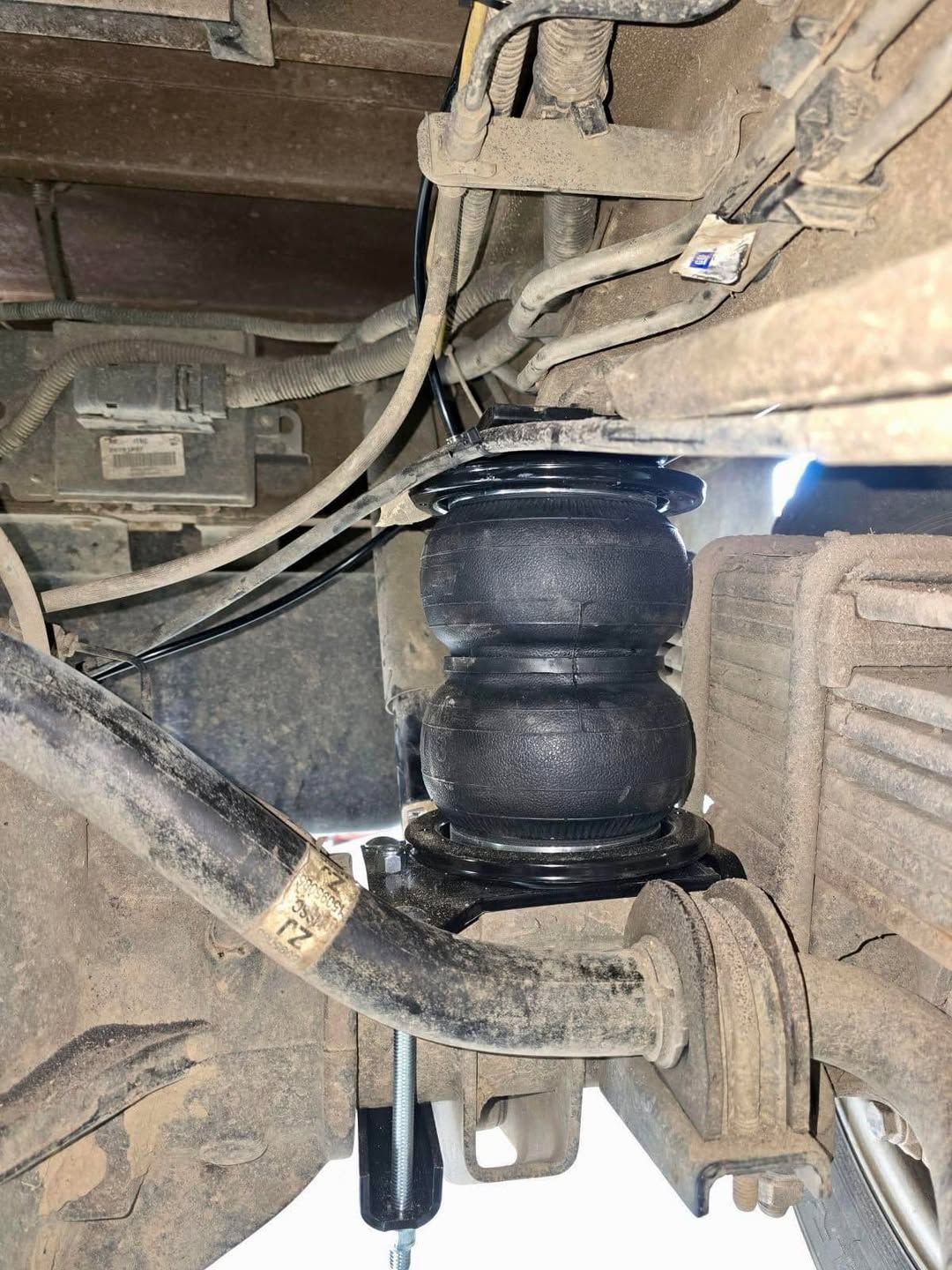 A close up of a suspension system on a truck.