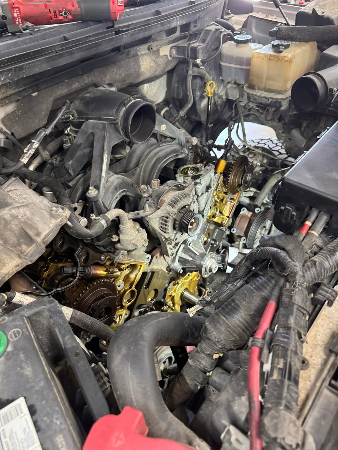 A close up of a car engine with a lot of junk in it.