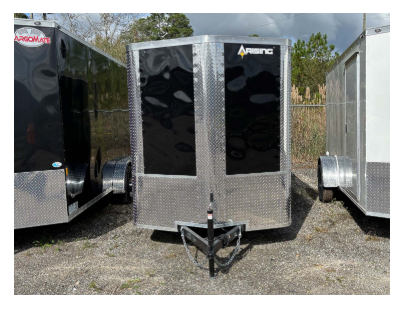 Three enclosed trailers parked outdoors; the central one has a black front and a diamond-plate metal finish.