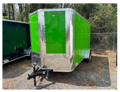 Bright green enclosed cargo trailer with silver accents, parked on gravel.