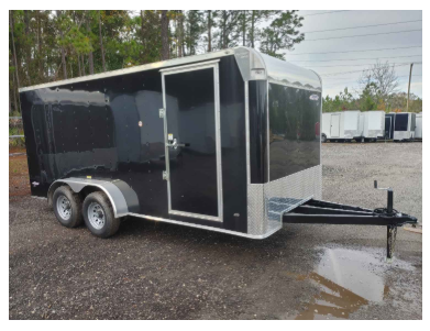 Black enclosed cargo trailer with silver accents, parked on gravel.