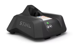 Black STIHL battery charger with the brand name on the side, a green power light, and two icons on the front.