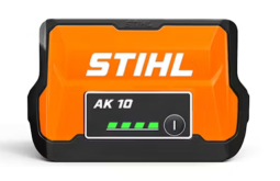 Stihl AK 10 battery pack, orange and black, with a green battery charge indicator.