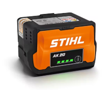 STIHL AK 20 orange and black battery pack with green charge indicator lights.
