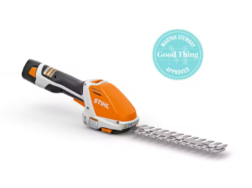 Battery-powered orange and white STIHL hedge trimmer with a Martha Stewart 