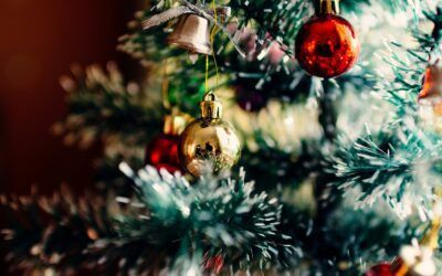 Close-up of a decorated Christmas tree with red and gold ornaments and tinsel