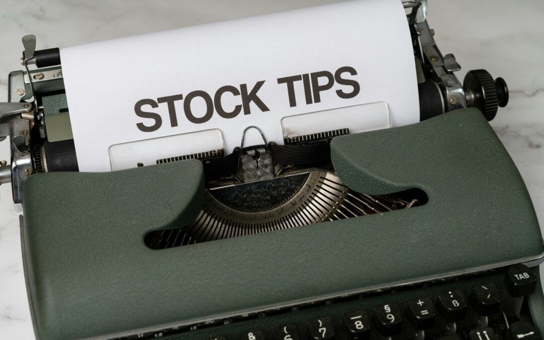 Close-up of a vintage typewriter with a paper reading “STOCK TIPS” in the carriage