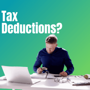 Man reviewing paperwork at a desk with laptop, calculator, and glasses beside “Tax Deductions?” text
