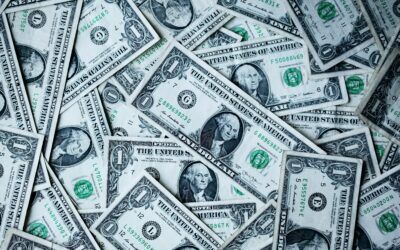 Scattered U.S. one-dollar bills filling the frame