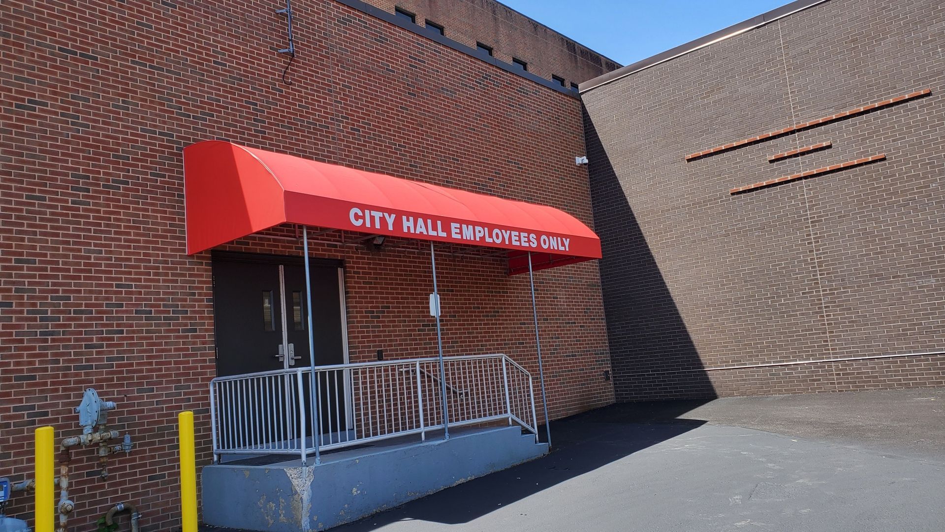 bright red employees only entrance awning
