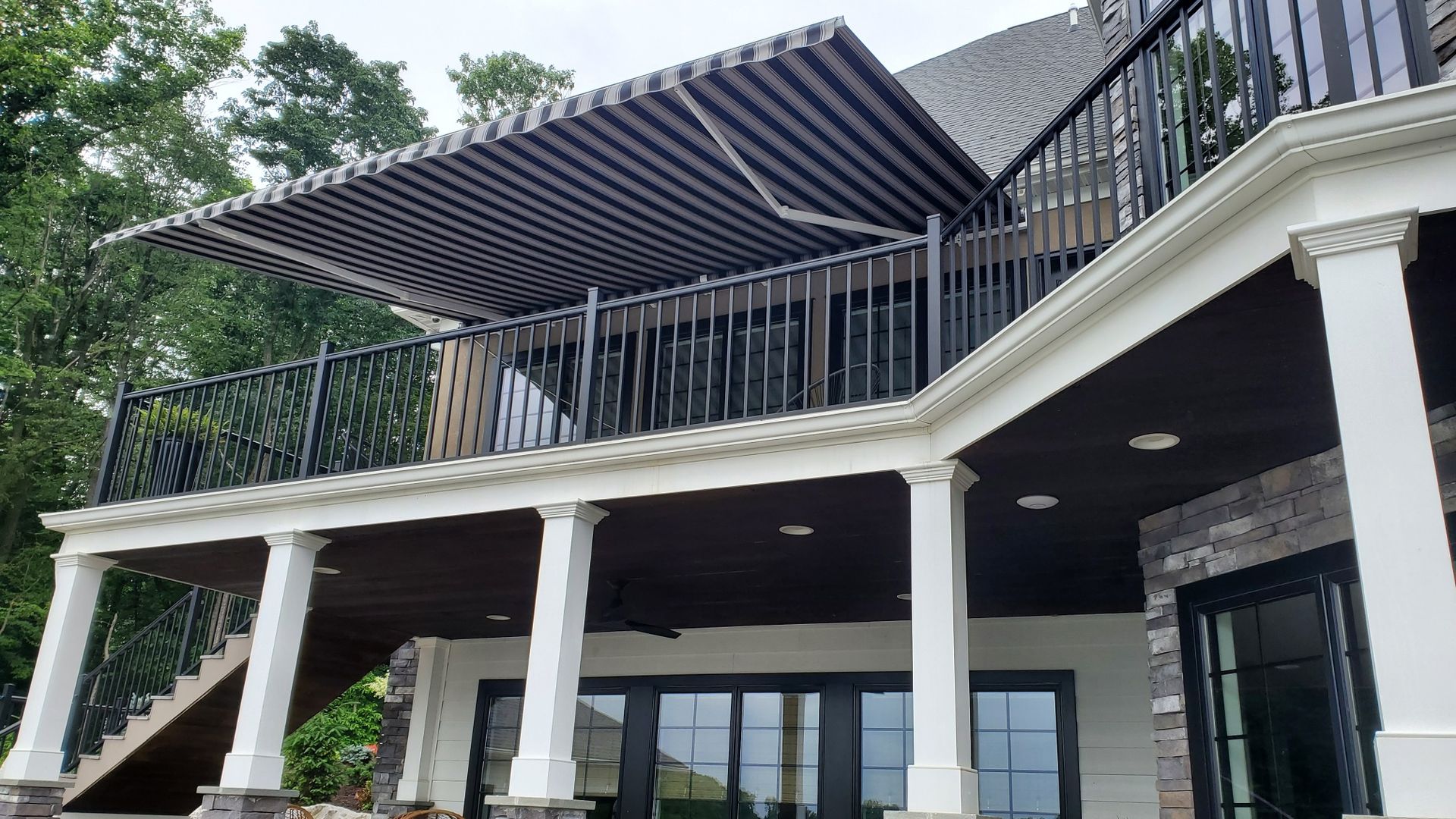 stripes retractable awning at the second floor