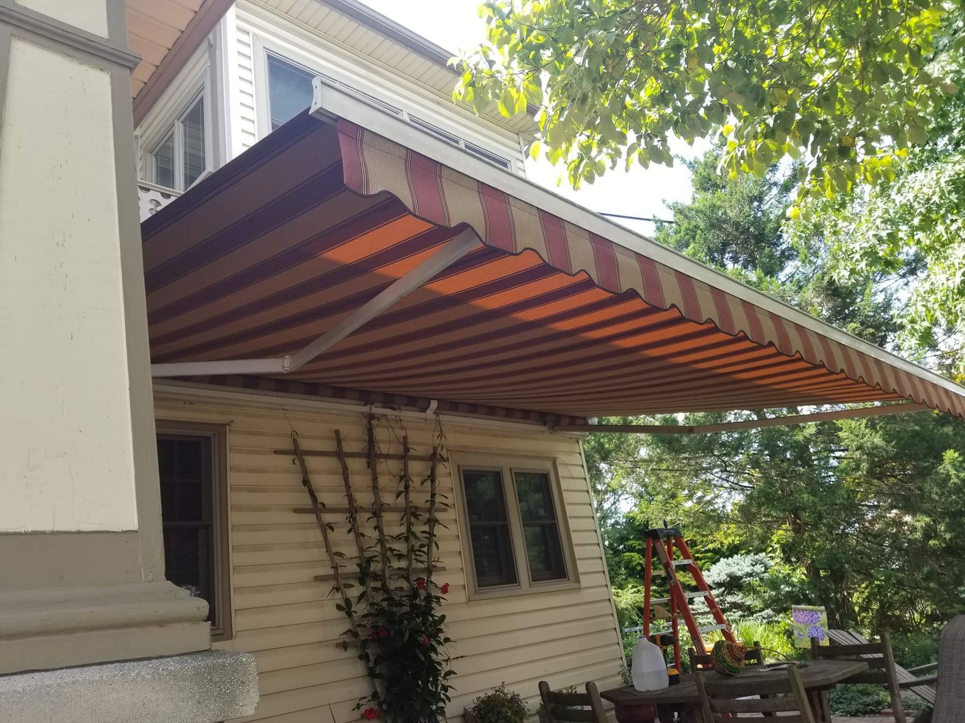maroon and beige retractable awning