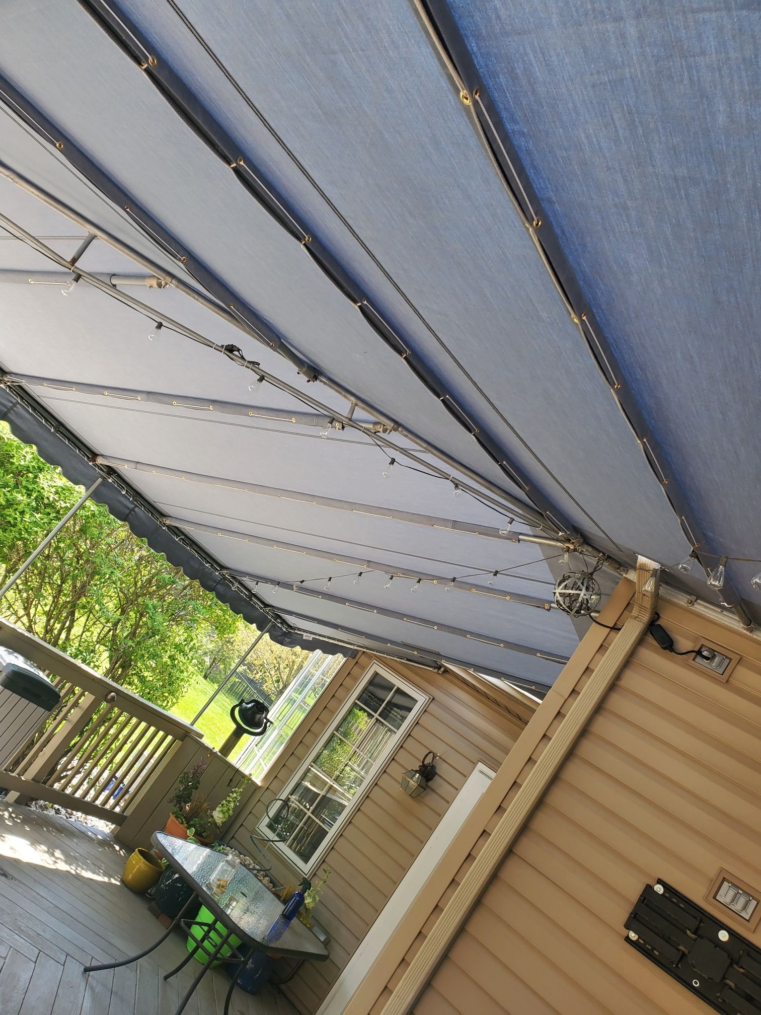 blue stationary patio cover with lights