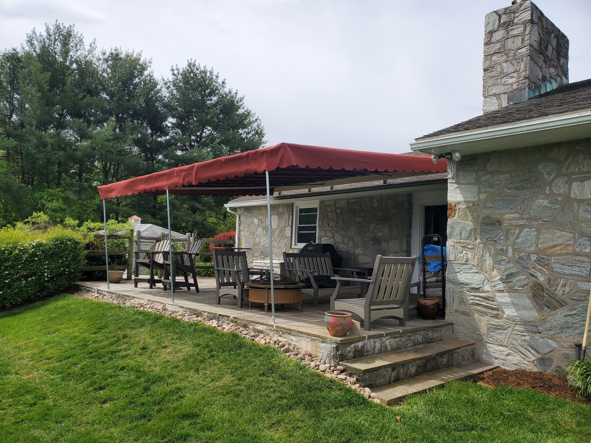 red stationary patio cover with poles