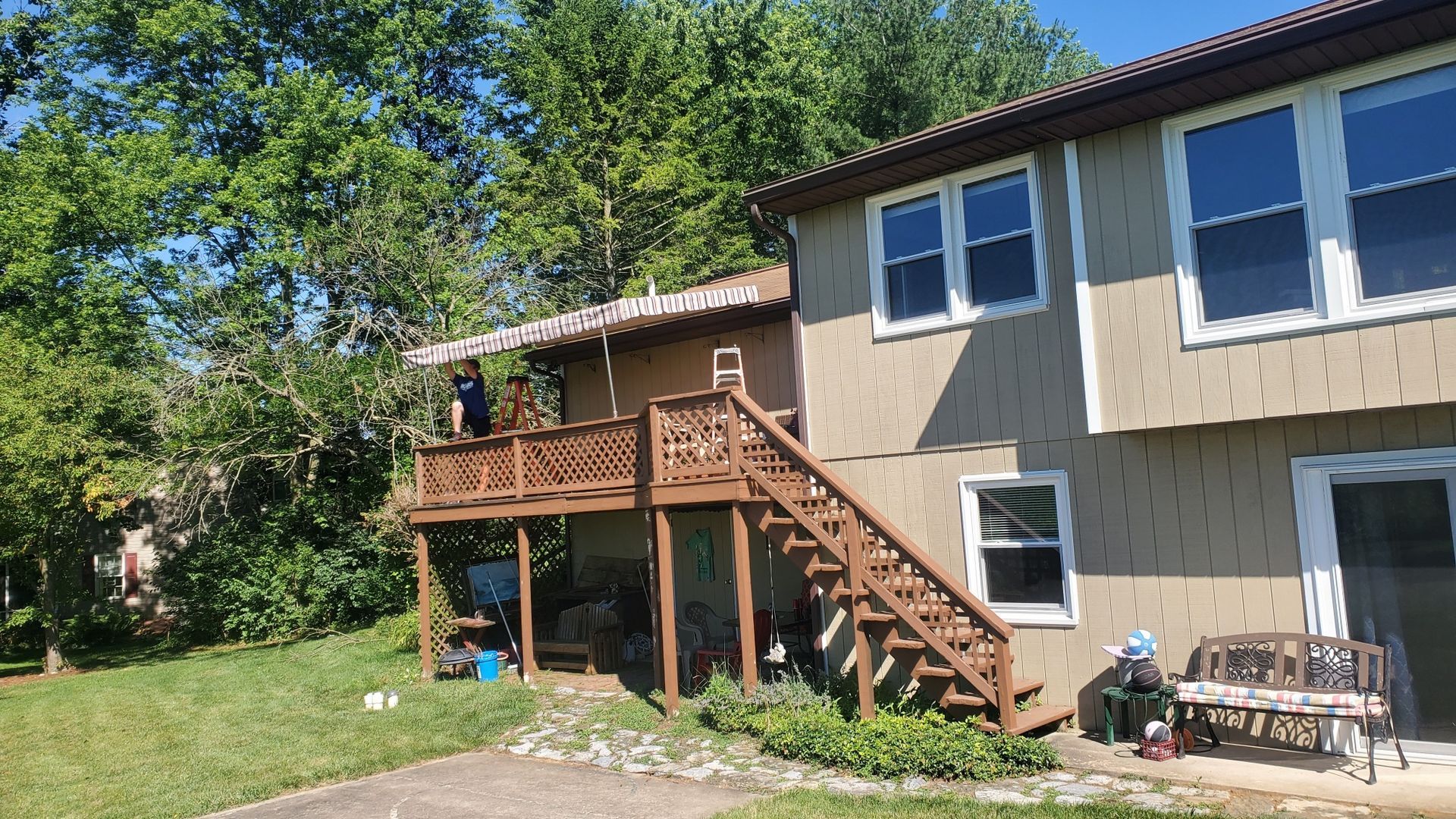 man installing stationary patio cover