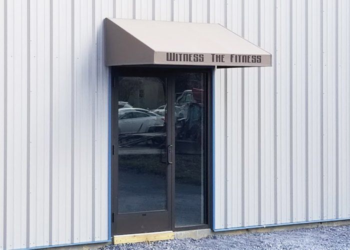 witness the fitness commercial door awning