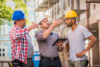 Learn More About Workers' Compensation Workers talking to each other