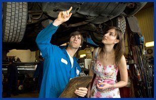 Mechanic pointing out the car problem