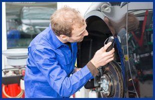 Mechanic repairing the brakes