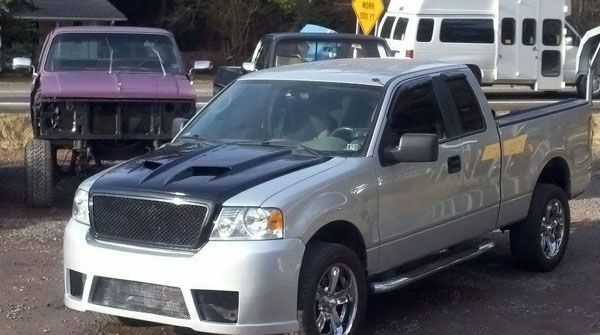 Silver colored truck with black hood