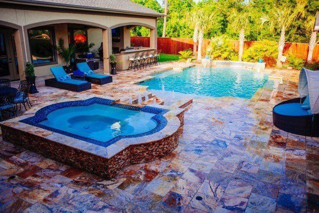 a large swimming pool with a hot tub in the middle of it .