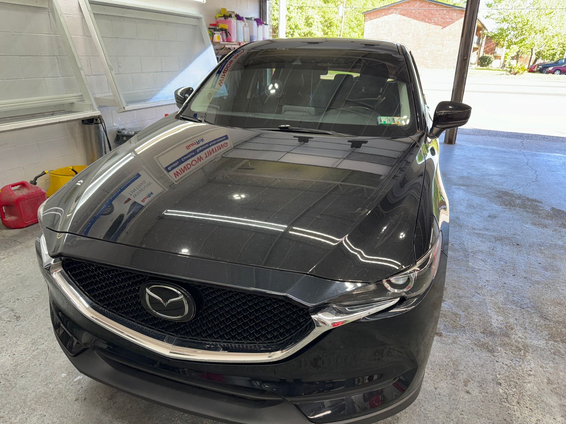 A black mazda cx 5 is parked in a garage.