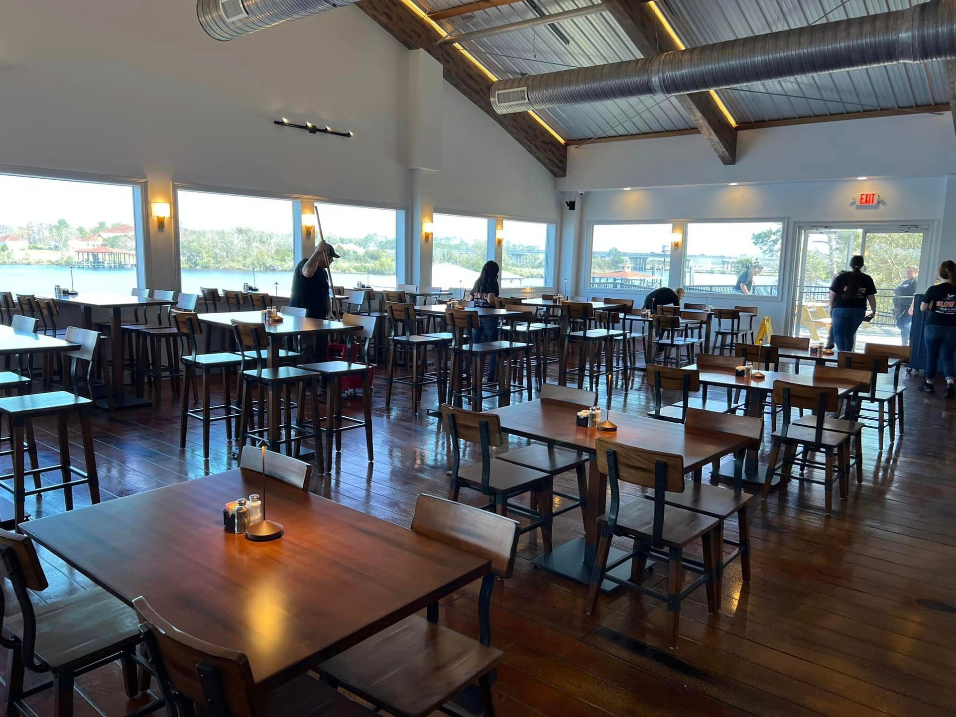 A large room filled with tables and chairs in a restaurant.