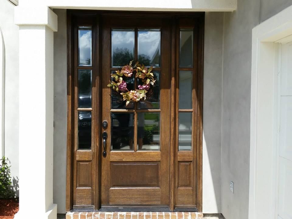 A wooden door with a wreath hanging from it