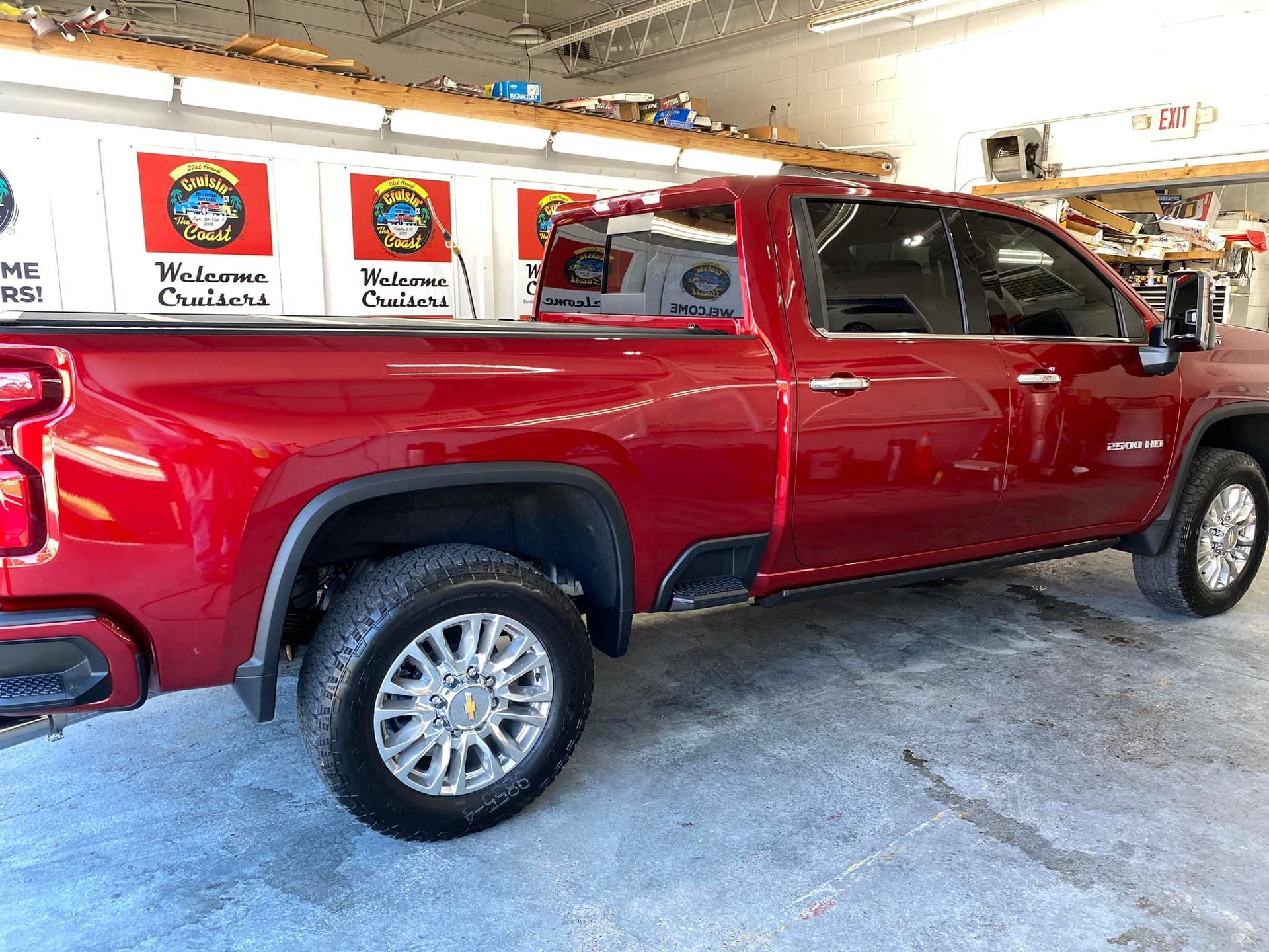A red pickup truck is parked in a garage.