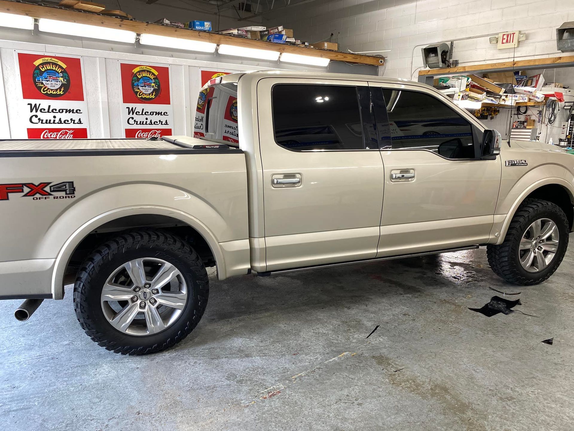 A white pickup truck is parked in a garage.