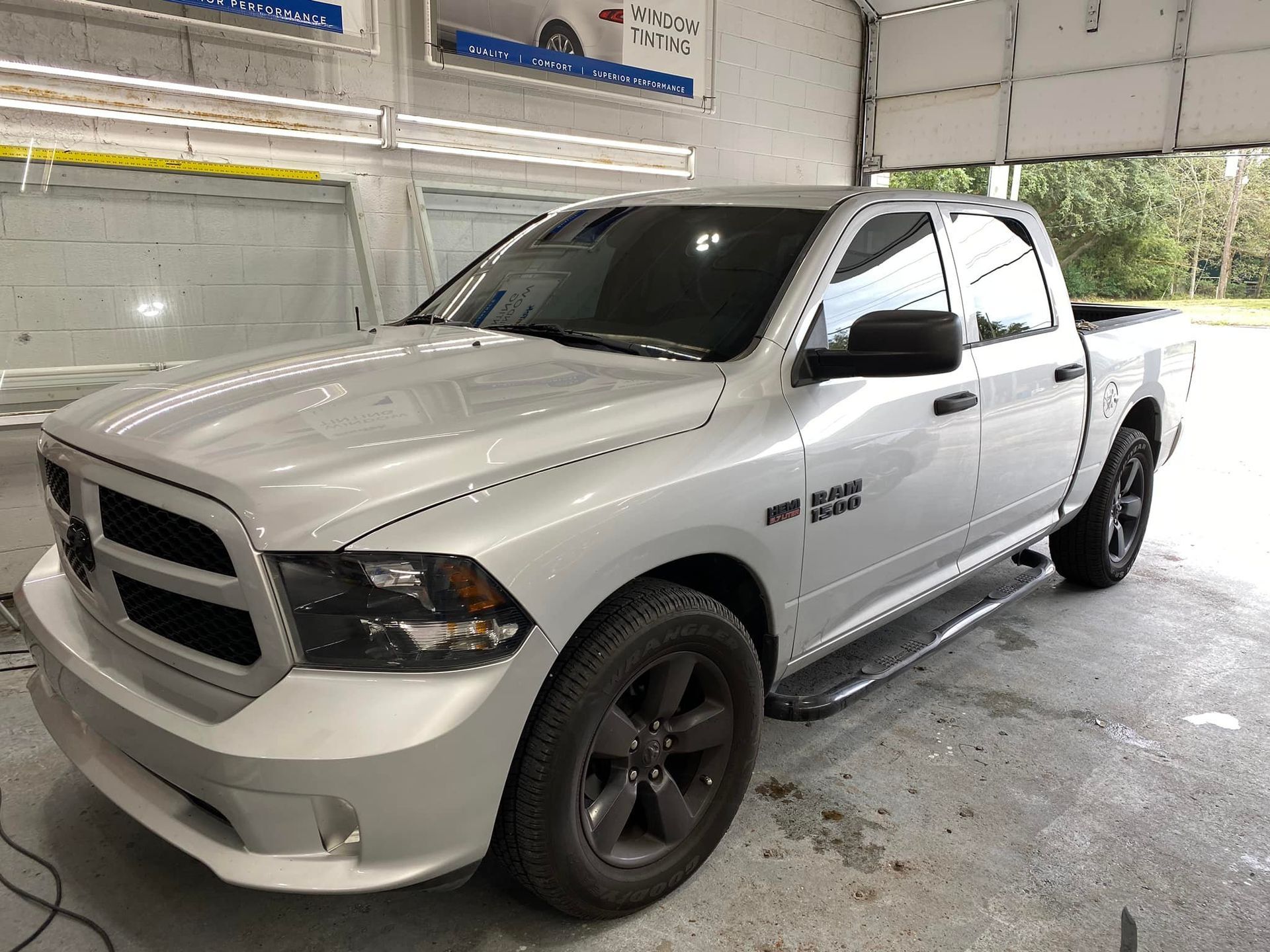 A white dodge ram truck is parked in a garage.